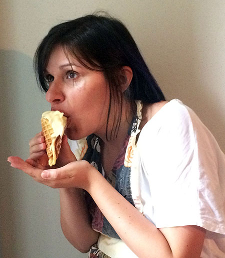 Sarah eating ambergris ice cream in a cone