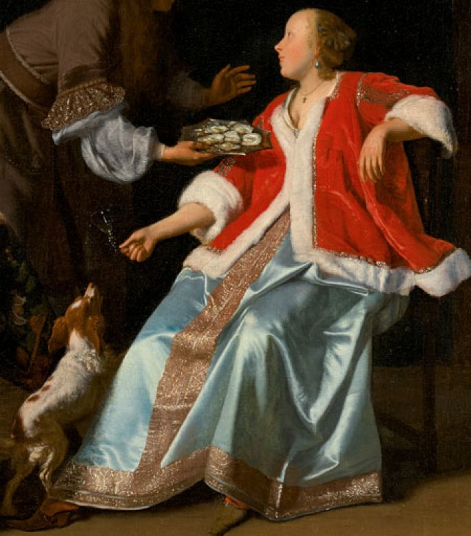 Close up of an oil painting that shows a hand bearing a small tray of oysters entering the frame from the upper left, offering it to a woman seated on the right. She is wearing an opulent blue silk dress and bright red, fur-trimmed coat. A small white and brown dog leaps upward on the left, eager for the oysters.