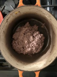A grayish paste sits inside the same stew pot